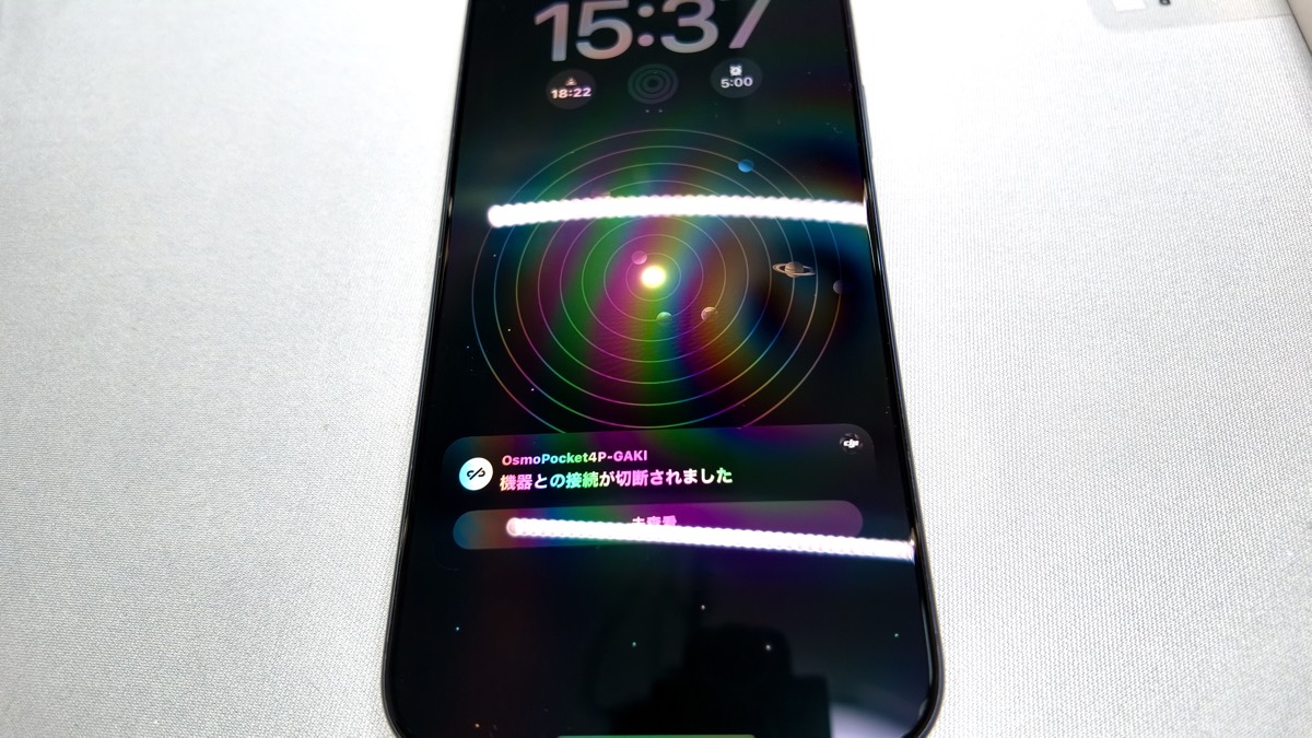 OrigArmor AR反射防止フィルムを貼ったiPhoneにモニターライトの光が映り込んでいる様子